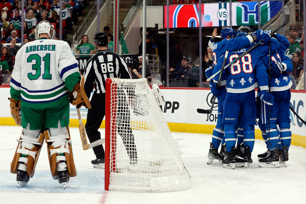 Colorado Avalanche celebrate a goal by Brock Nelson, with Carolina Hurricanes goaltender Frederik Andersen (31) standing near the net during the third period of an NHL hockey game in Raleigh, N.C., Saturday, Jan. 3, 2026. (AP Photo/Karl DeBlaker)
