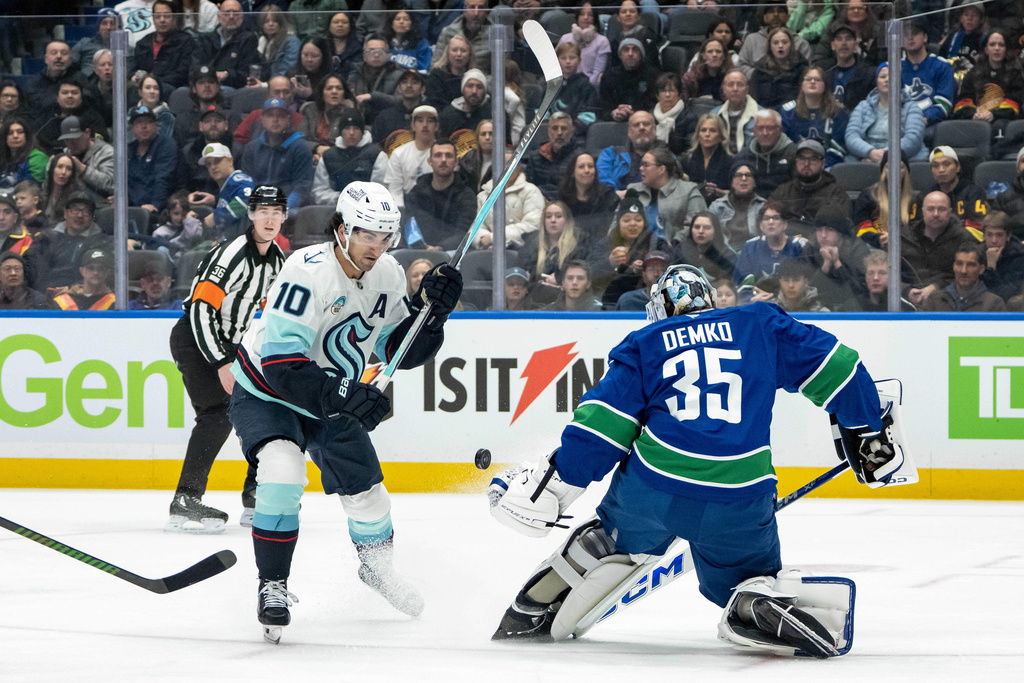 Vancouver Canucks goaltender Thatcher Demko (35) stops Seattle Kraken's Matty Beniers (10) during the first period of an NHL game in Vancouver, Friday, Jan. 2, 2026. (Ethan Cairns/The Canadian Press via AP)