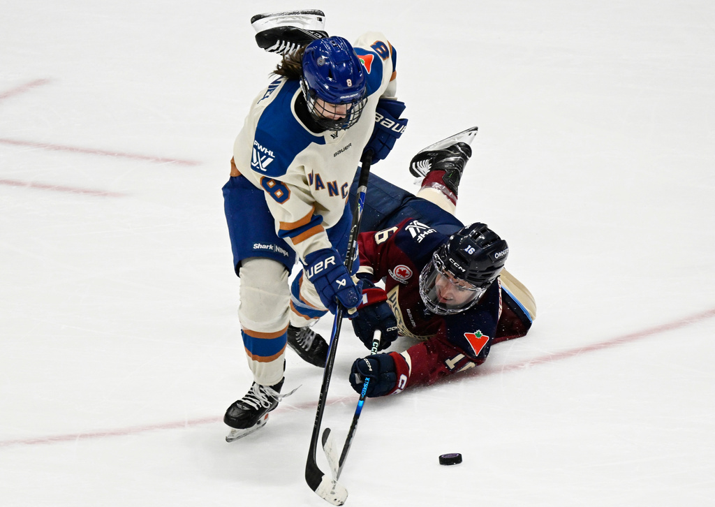 Montreal Victoire's Hayley Scamurra (16) and Vancouver Goldeneyes' Izzy Daniel (8) chase the puck during third-period PWHL hockey game action in Quebec City, Sunday, Jan. 11, 2026. (Jacques Boissinot/The Canadian Press via AP)
