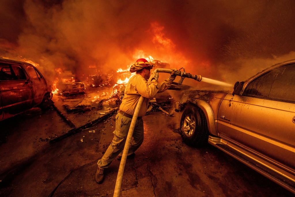FILE - A firefighter battles the Eaton Fire, Jan. 8, 2025, in Altadena, Calif. (AP Photo/Ethan Swope, File)
