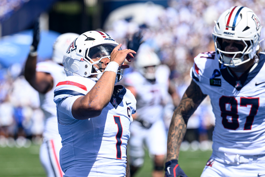 Arizona quarterback Noah Fifita (1) celebrates scoring a touchdown during the first half an NCAA college football game against BYU, Saturday, Sept. 12, 2026, in Provo, Utah. (AP Photo/Tyler Tate)