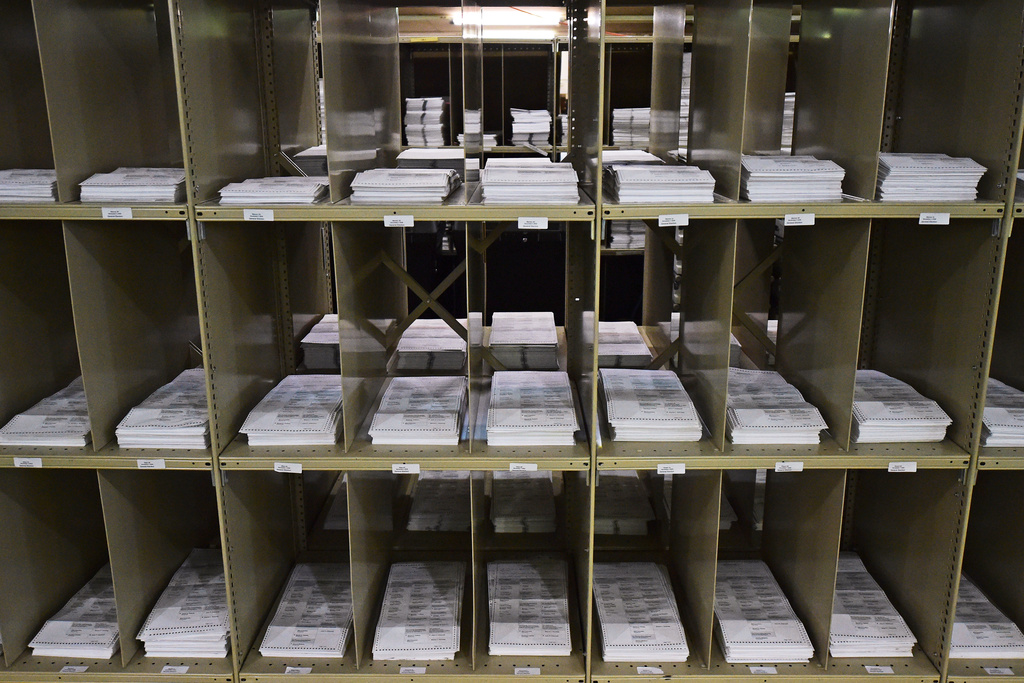 FILE - Mail-in ballots sit on shelves inside the Trumbull County Board of Elections, Nov. 3, 2020, in Warren, Ohio. (AP Photo/David Dermer, File)