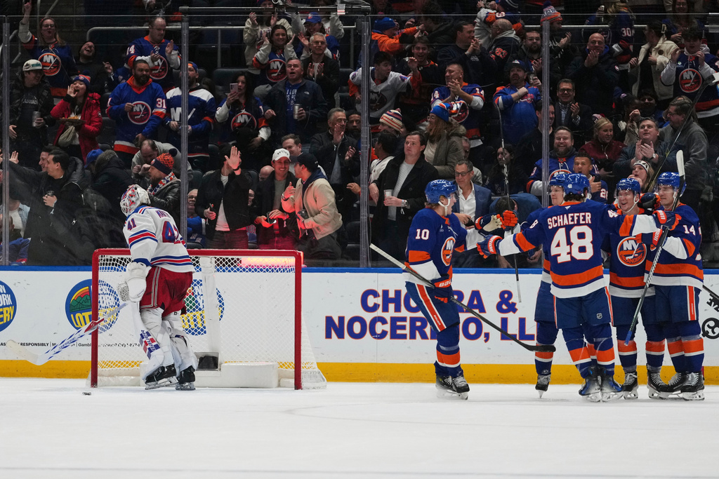 New York Rangers goaltender Spencer Martin (41) skates away as the New York Islanders celebrate a goal by Ondrej Palat during the first period of an NHL hockey game Wednesday, Jan. 28, 2026, in Elmont, N.Y. (AP Photo/Frank Franklin II)