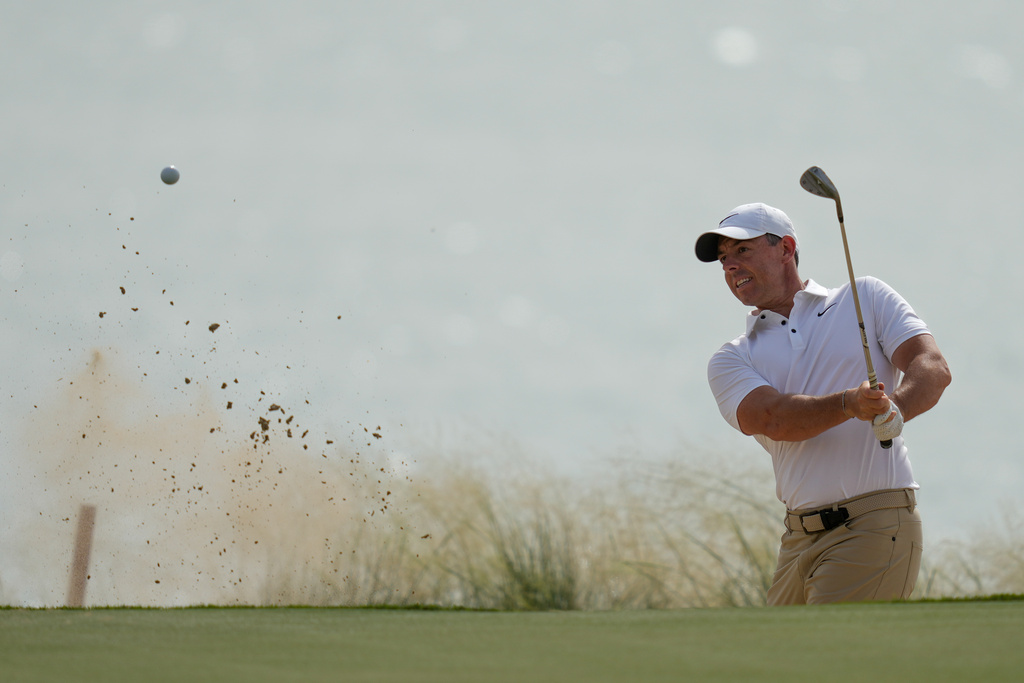 Rory McIlroy of Northern Ireland hits a shot from a bunker on the 18th hole during the first round of the Abu Dhabi Golf Championship in Abu Dhabi, United Arab Emirates, Thursday, Nov. 6, 2025. (AP Photo/Altaf Qadri)