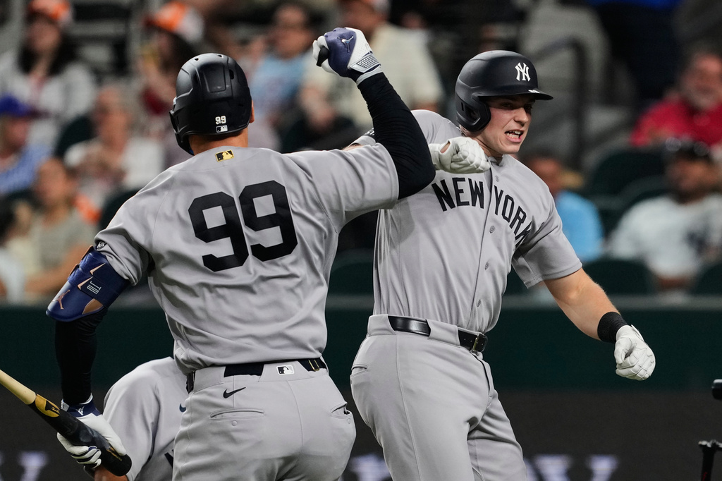 New York Yankees' Aaron Judge and Ben Rice, right, celebrate Rice's two-run home run in the third inning of a baseball game against the Texas Rangers Monday, April 27, 2026, in Arlington, Texas. (AP Photo/Tony Gutierrez)