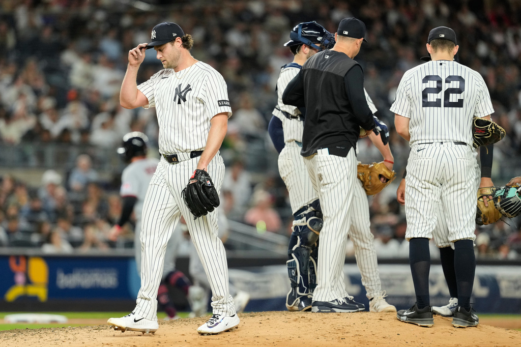 New York Yankees pitcher Gerrit Cole, left, is pulled from the game during the sixth inning of a baseball game against the Cleveland Guardians, Wednesday, June 3, 2026, in New York. (AP Photo/Seth Wenig)
