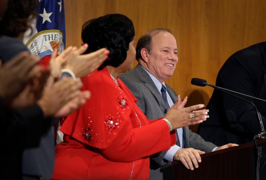 FILE - Detroit Mayor Mike Duggan is applauded by City Council members before delivering his first State of the City address, Feb. 26, 2014, in Detroit. (AP Photo/Carlos Osorio, File)