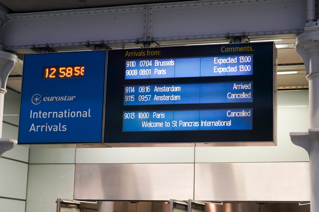 The screen board displays the trains' arrival status at St Pancras International train station in London, Tuesday, Dec. 30, 2025 after Eurostar asked train customers not to travel because of disruption in the Channel Tunnel. (AP Photo/Alberto Pezzali)