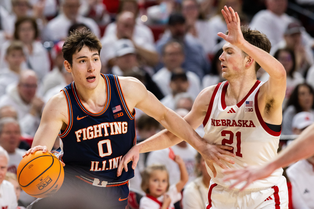 Illinois forward David Mirkovic (0) drives past Nebraska forward Pryce Sandfort (21) during the second half of an NCAA college basketball game, Sunday, Feb. 1, 2026, in Lincoln, Neb. (AP Photo/Bonnie Ryan)