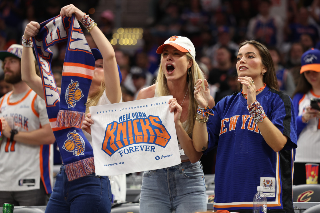 New York Knicks fans cheer during the second half of Game 4 in the Eastern Conference finals NBA basketball playoffs series against the Cleveland Cavaliers in Cleveland, Monday, May 25, 2026. (AP Photo/Tim Phillis)