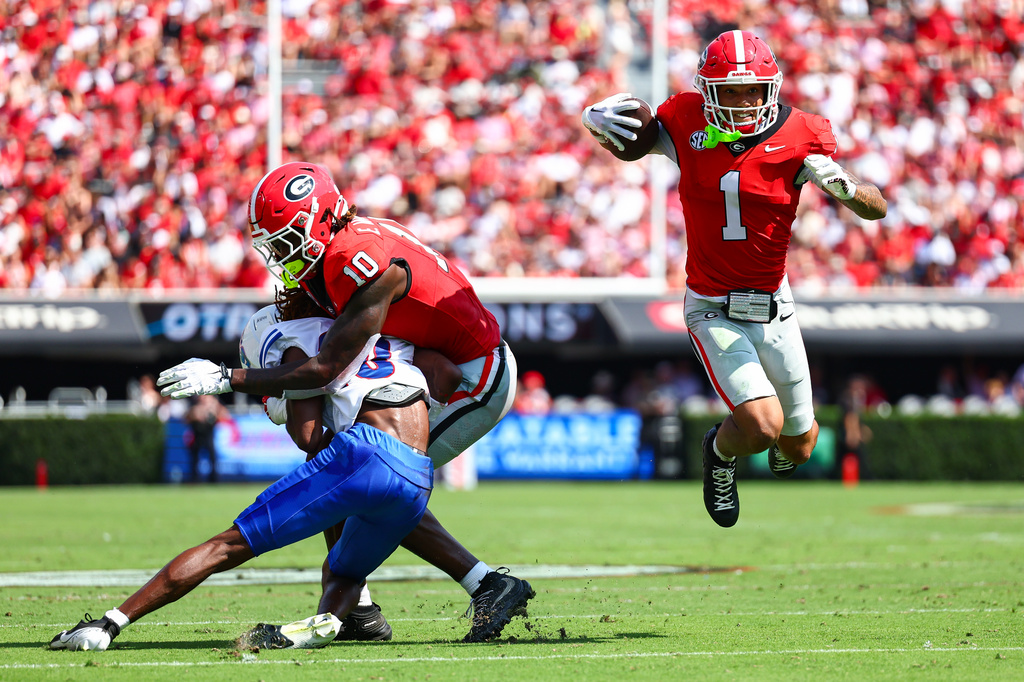 Georgia wide receiver Talyn Taylor (1) runs with the ball while tight end Elyiss Williams (10) blocks Tennessee State defensive back Syncere Safeeullah, left, during the first half of an NCAA college football game, Saturday, Sept. 5, 2026, in Athens, Ga. (AP Photo/Colin Hubbard)