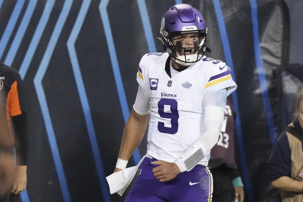 Minnesota Vikings quarterback J.J. McCarthy celebrates after scoring during the second half of an NFL football game against the Chicago Bears Monday, Sept. 8, 2025, in Chicago. (AP Photo/Nam Y. Huh)