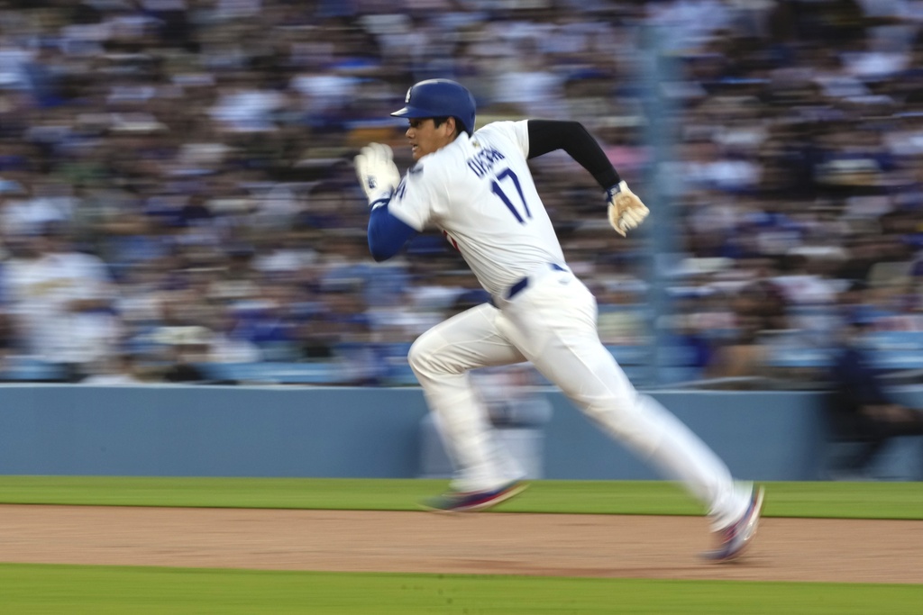 Los Angeles Dodgers' Shohei Ohtani attempts the steal third before being called back for a foul ball during the first inning of a baseball game against the Toronto Blue Jays, Friday, Aug. 8, 2025, in Los Angeles. (AP Photo/Mark J. Terrill)