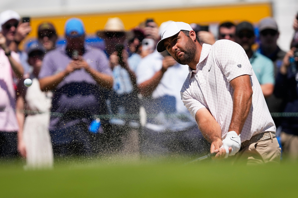 Scottie Scheffler hits from the bunker on the first hole during the third round of the U.S. Open golf tournament at Shinnecock Hills Golf Club in Southampton, N.Y., Saturday, June 20, 2026.(AP Photo/David J. Phillip)