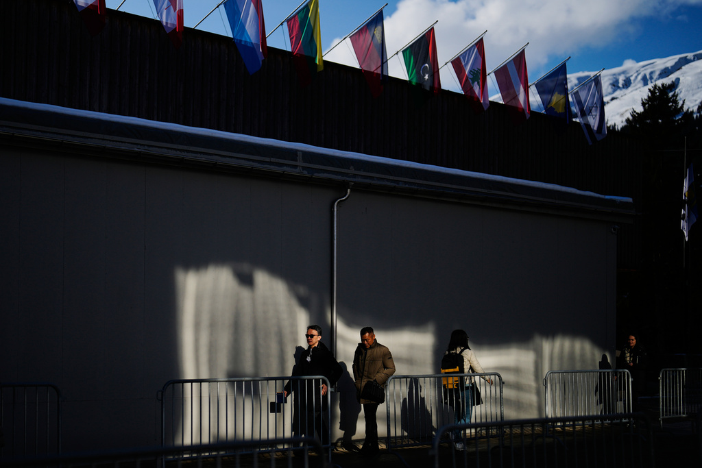 People walk at the Promenade in front of the Congress Center where the Annual Meeting of the World Economy Forum take place in Davos, Switzerland, Monday, Jan. 19, 2026. (AP Photo/Markus Schreiber)