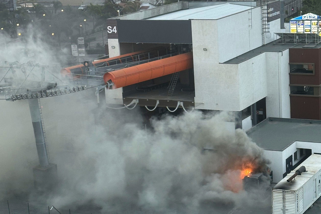 Protesters set fire to a newly built cable car station, which only operates for three hours a day, powered by a generator due to a lack of electricity in the capital, in Antananarivo, Madagascar, Thursday, Sept. 25, 2025. (AP Photo/Sarah Tetaud)