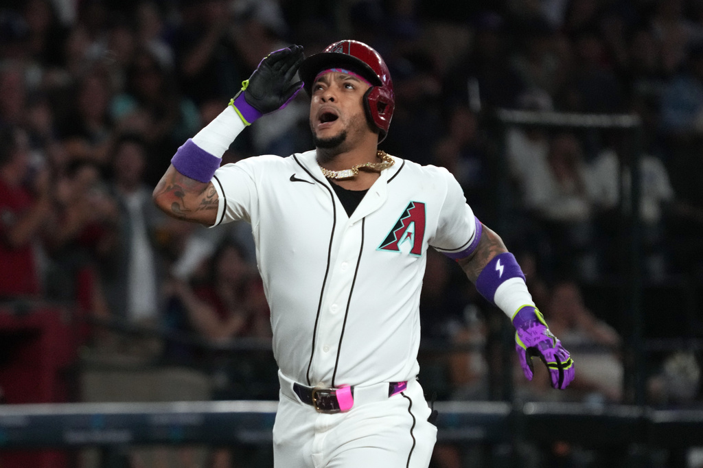 Arizona Diamondbacks' Ketel Marte reacts after hitting a two-run home run against the Los Angeles Dodgers in the first inning of a baseball game, Sunday, Aug 9, 2026, in Phoenix. (AP Photo/Rick Scuteri)