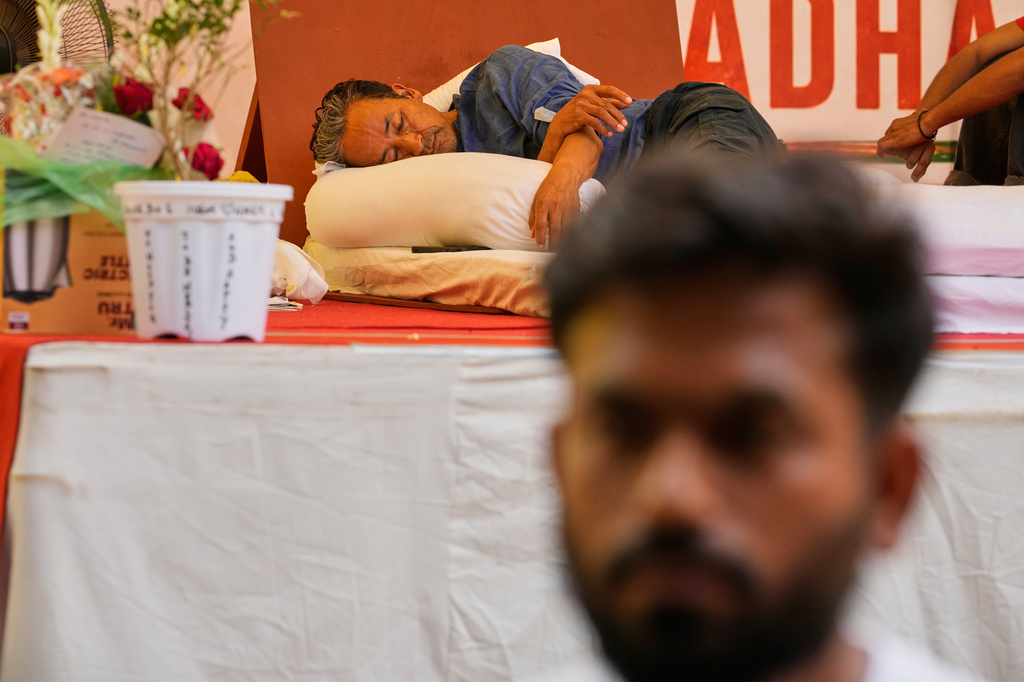Educationist and climate activist Sonam Wangchuk undertakes an indefinite hunger strike as Abhijeet Dipke, founder of the Cockroach Janta Party, foreground, talks during a protest demanding the resignation of Education Minister Dharmendra Pradhan over alleged examination irregularities and repeated paper leaks in New Delhi, India, on July 14, 2026. (AP Photo/Manish Swarup)