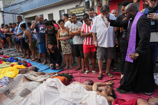 FILE - A priest blesses the bodies of people killed the day before during a police raid targeting the Comando Vermelho gang in the Complexo da Penha favela of Rio de Janeiro, Brazil, Wednesday, Oct. 29, 2025. (AP Photo/Silvia Izquierdo, File) FILE - A priest blesses the bodies of people killed the day before during a police raid targeting the Comando Vermelho gang in the Complexo da Penha favela of Rio de Janeiro, Brazil, Wednesday, Oct. 29, 2025. (AP Photo/Silvia Izquierdo, File)