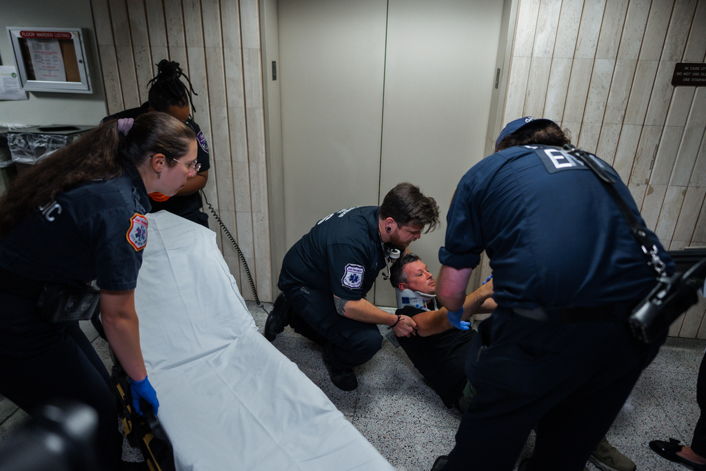 Medics transfer journalist L. Vural Elibol to a gurney after he was shoved by federal agents in immigration court on Tuesday, Sept. 30, 2025, in New York. (AP Photo/Olga Fedorova)