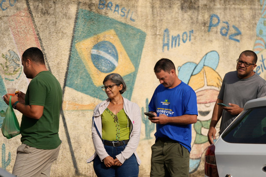 Voters line up at a polling station during general elections in Brasilia, Brasilia, Sunday, Oct. 4, 2026. (AP Photo/Eraldo Peres)