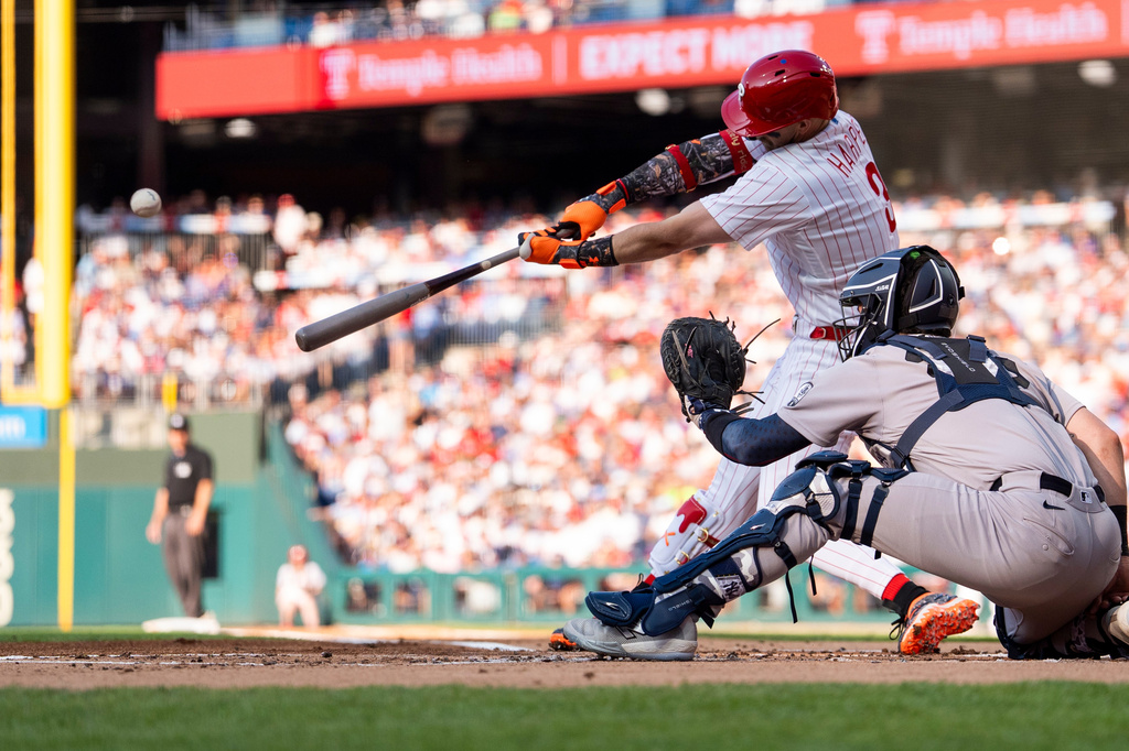 Philadelphia Phillies' Bryce Harper hits a sacrifice fly to score Trea Turner during the first inning of a baseball game against the New York Yankees, Saturday, July 25, 2026, in Philadelphia. (AP Photo/Chris Szagola)