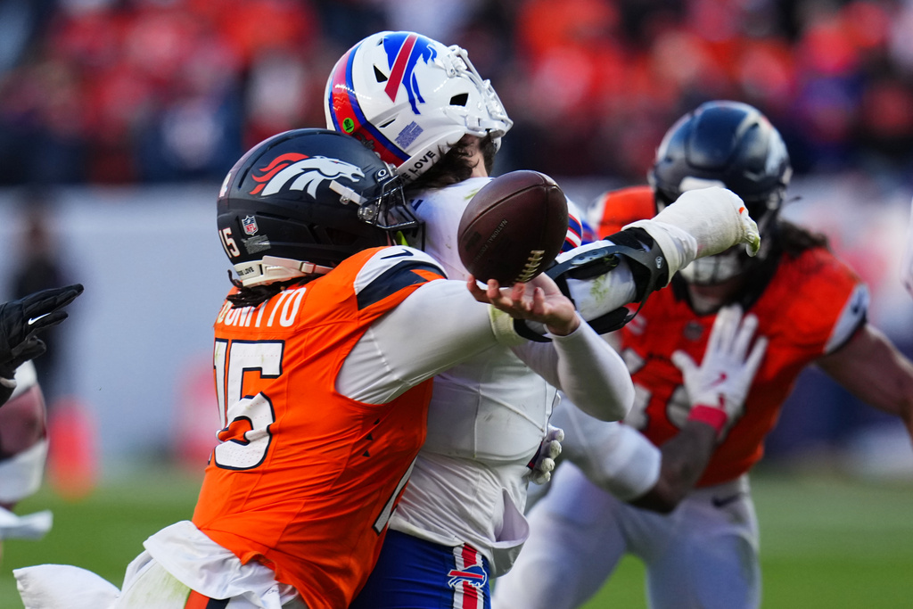 Buffalo Bills quarterback Josh Allen (17) fumbles the ball while being tackled by Denver Broncos linebacker Nik Bonitto (15) during the second half of an NFL divisional round playoff football game, Saturday, Jan. 17, 2026, in Denver. (AP Photo/Jack Dempsey)