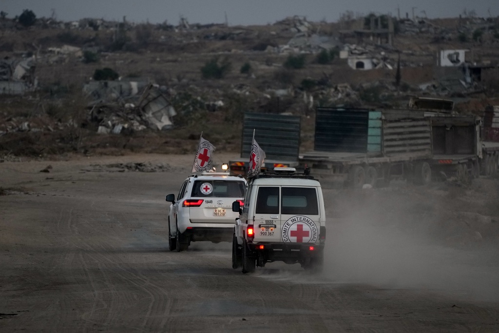 Red Cross vehicles carrying the bodies of two people believed to be deceased hostages handed over by Hamas make their way toward the Kissufim border crossing with Israel, to be transferred to Israeli authorities, in Deir al-Balah, central Gaza Strip, Thursday, Oct. 30, 2025. (AP Photo/Abdel Kareem Hana)