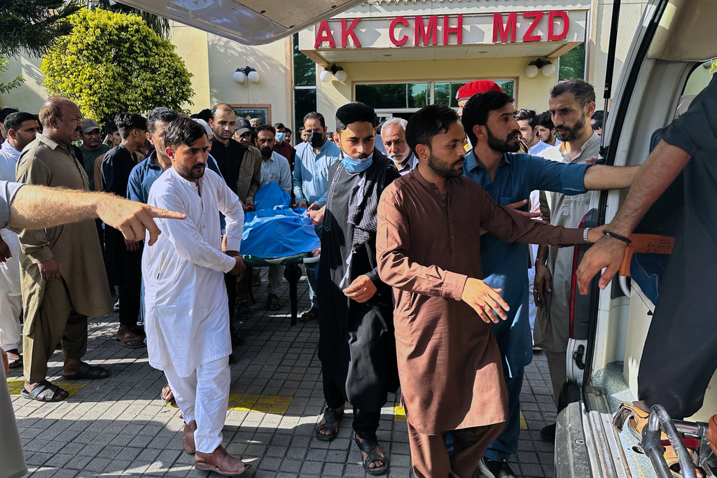 People transport the body of a person, who was killed in the clashes between police and demonstrators demanding subsidies on food, cheaper electricity and other concession, at a hospital in Muzaffarabad, the capital of Pakistani controlled Kashmir, Wednesday, Oct. 1, 2025. (AP Photo/M.D. Mughal)
