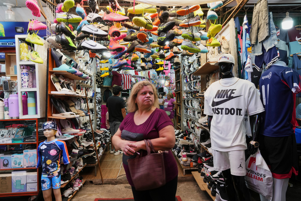 A woman shops at a store that primarily sells sports clothing imported from China in Asuncion, Paraguay, Saturday, Jan. 31, 2026. (AP Photo/Jorge Saenz)
