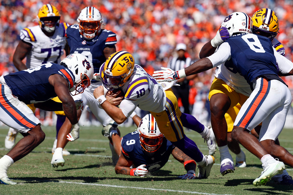 LSU quarterback Sam Leavitt (10) dives for the touchdown as Auburn linebacker Bryce Deas (16) defends during the first half of an NCAA college football game, Saturday, Oct. 24, 2026, in Auburn, Ala. (AP Photo/Butch Dill)