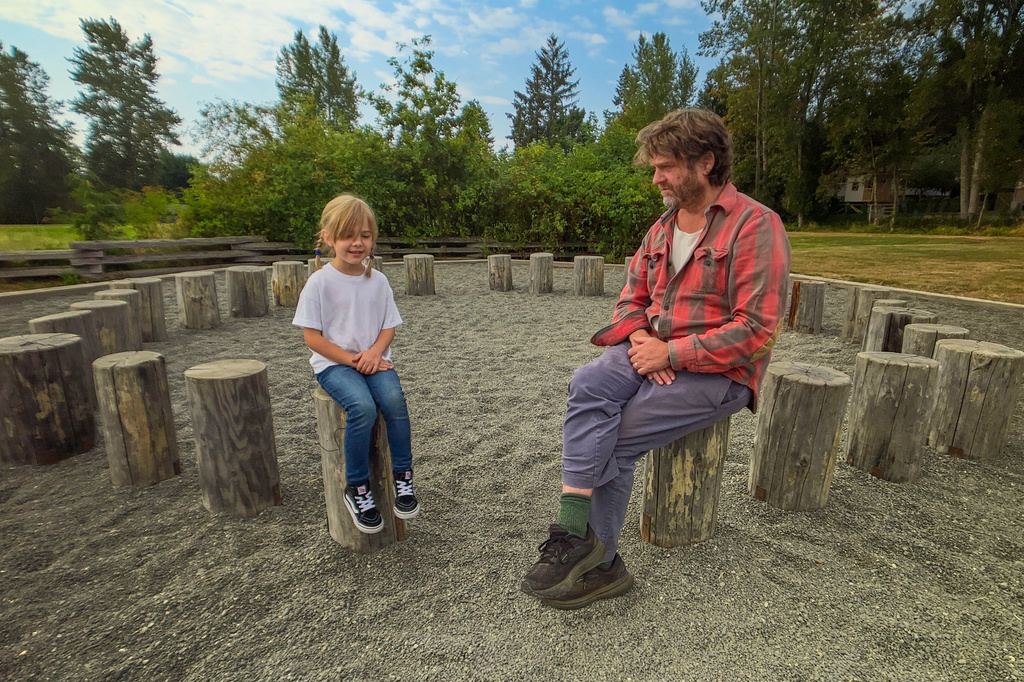 This image released by Netflix shows Zach Galifianakis, right, interviewing a child about root vegetables in a scene from his gardening series "This Is a Gardening Show." (Netflix via AP)