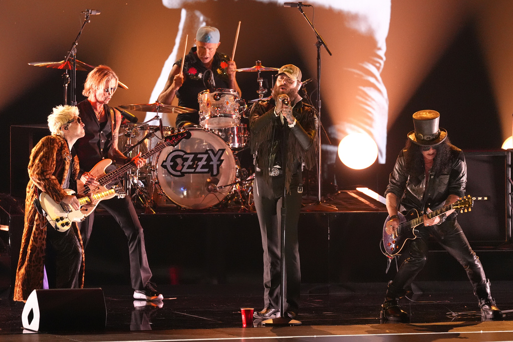 Andrew Watt, from left, Duff McKagan, Chad Smith, Post Malone and Slash perrform "War Pigs" during the in memoriam tribute for the 68th annual Grammy Awards on Sunday, Feb. 1, 2026, in Los Angeles. (AP Photo/Chris Pizzello)
