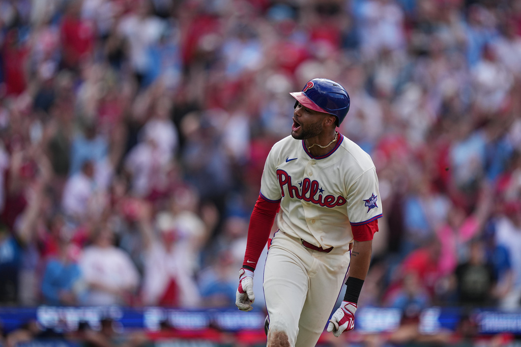 Philadelphia Phillies' Justin Crawford reacts after hitting a one run-single off of Washington Nationals pitcher Cole Henry during the tenth inning of a baseball game, Wednesday, April 1, 2026, in Philadelphia. (AP Photo/Matt Rourke)