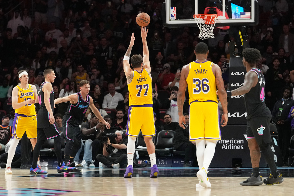 Los Angeles Lakers guard Luka Doncic (77) shoots a free throw to score sixty points during the second half of an NBA basketball game against the Miami Heat, Thursday, March 19, 2026, in Miami. (AP Photo/Lynne Sladky)