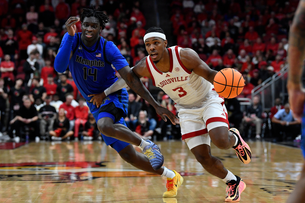Louisville guard Ryan Conwell (3) drives past Memphis guard Hasan Abdul Hakim (14) during the second half of an NCAA college basketball game in Louisville, Ky., Saturday, Dec. 13, 2025. (AP Photo/Timothy D. Easley)