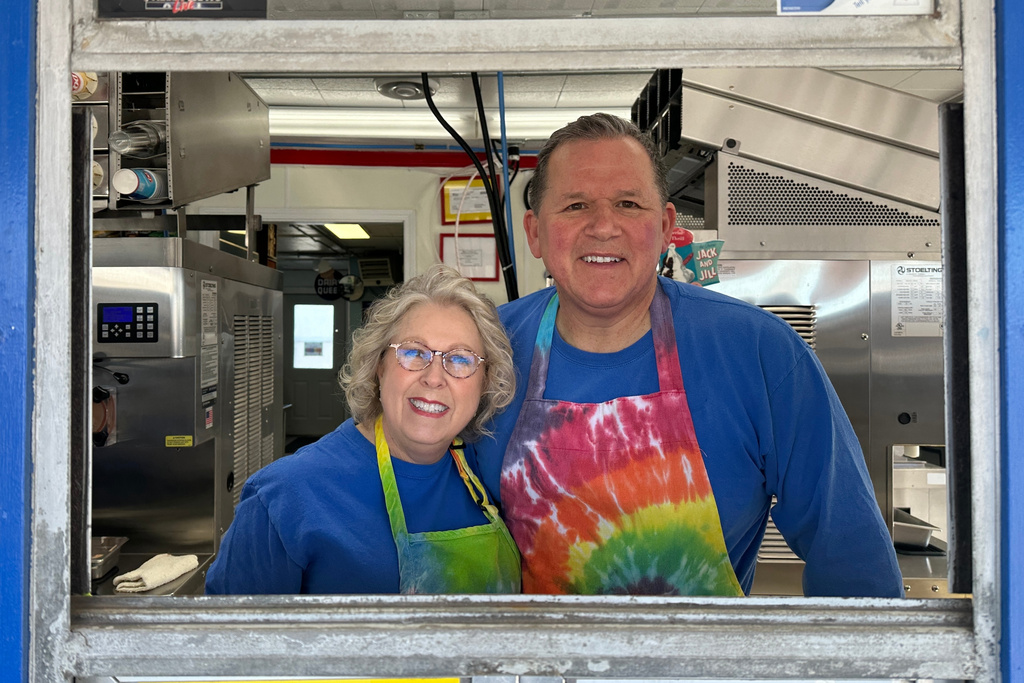 Moorhead Dairy Queen owners Diane, left, and Troy DeLeon pose for a photo Sunday, March 1, 2026, at the walk-up window of their Dairy Queen in Moorhead, Minn. (AP Photo/Jack Dura)