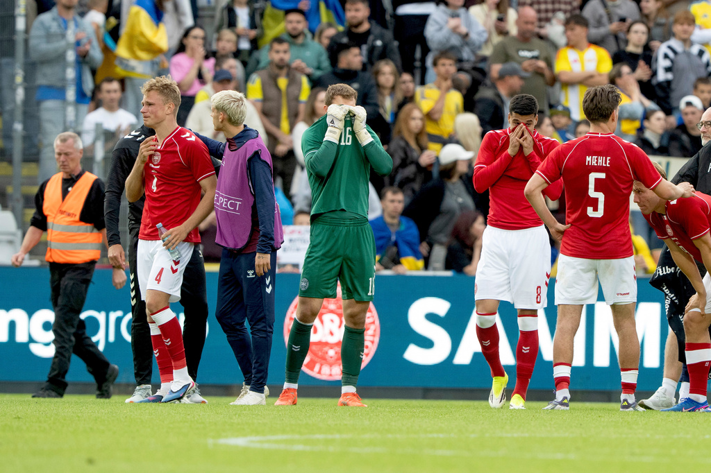 Denmark's Lukas Hoegsberg, Albert Groenbaek, goalkeeper Mads Hermansen, Adam Daghim, Joakim Maehle, and Rasmus Hoejlund react after Denmark's player Christian Eriksen collapses on the field during the international friendly soccer match between Denmark and Ukraine in Odense, Denmark, Sunday, June 7, 2026. (Bo Amstrup/Ritzau Scanpix via AP)