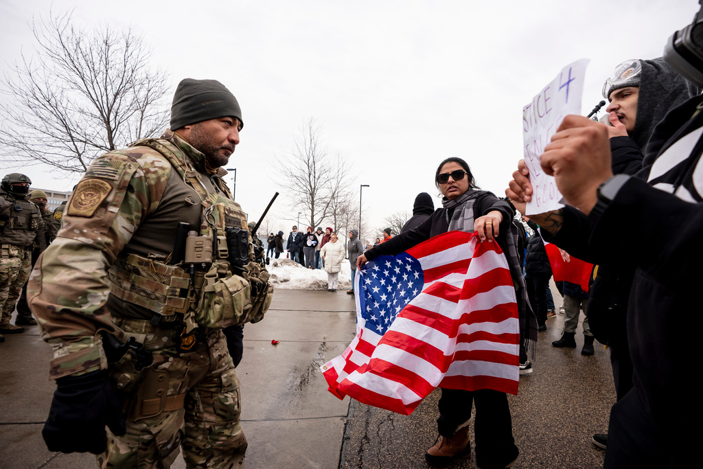 Federal agents and police clash with protesters outside the Bishop Henry Whipple Federal Building in Minneapolis, Minn. on Thursday, Jan. 8, 2026. (Christopher Katsarov/The Canadian Press via AP)