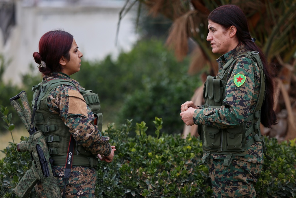 Rohlat Afrin, commander of the Syrian Democratic Forces (SDF) Women's Protection Units, right, talks with a soldier in Qamishli, Syria, Saturday, Jan. 31, 2026. (AP Photo/Baderkhan Ahmad)
