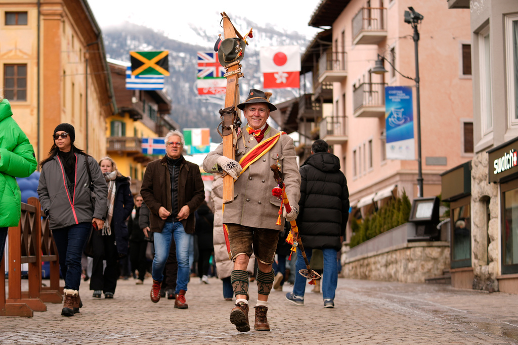 Walter Strohmeier, the director of a ski museum, walks amongst visitors at the 2026 Winter Olympics, in Cortina d'Ampezzo, Italy, Wednesday, Feb. 11, 2026. (AP Photo/Robert F. Bukaty)