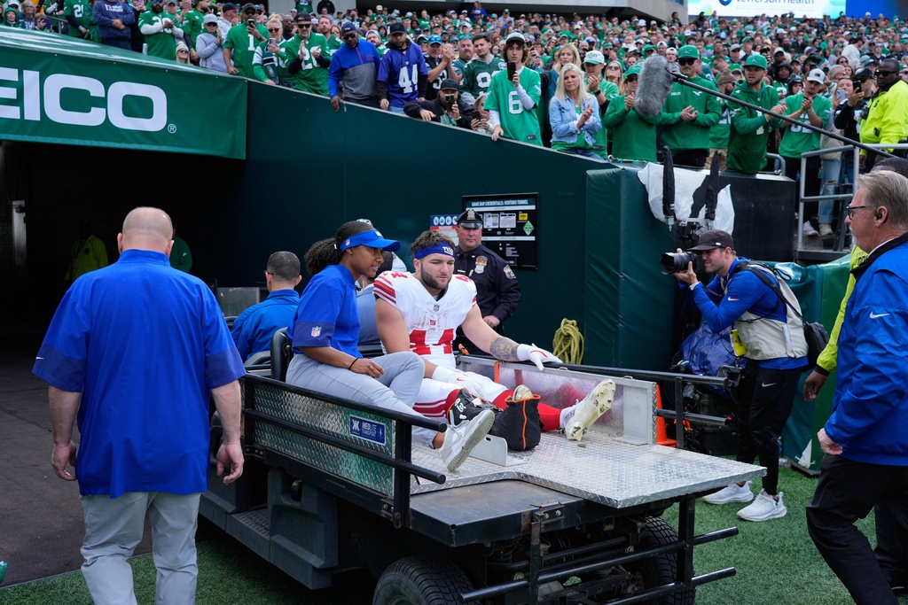 New York Giants running back Cam Skattebo (44) leaves the field after an injury during the first half of an NFL football game against the Philadelphia Eagles on Sunday, Oct. 26, 2025, in Philadelphia. (AP Photo/Chris Szagola)