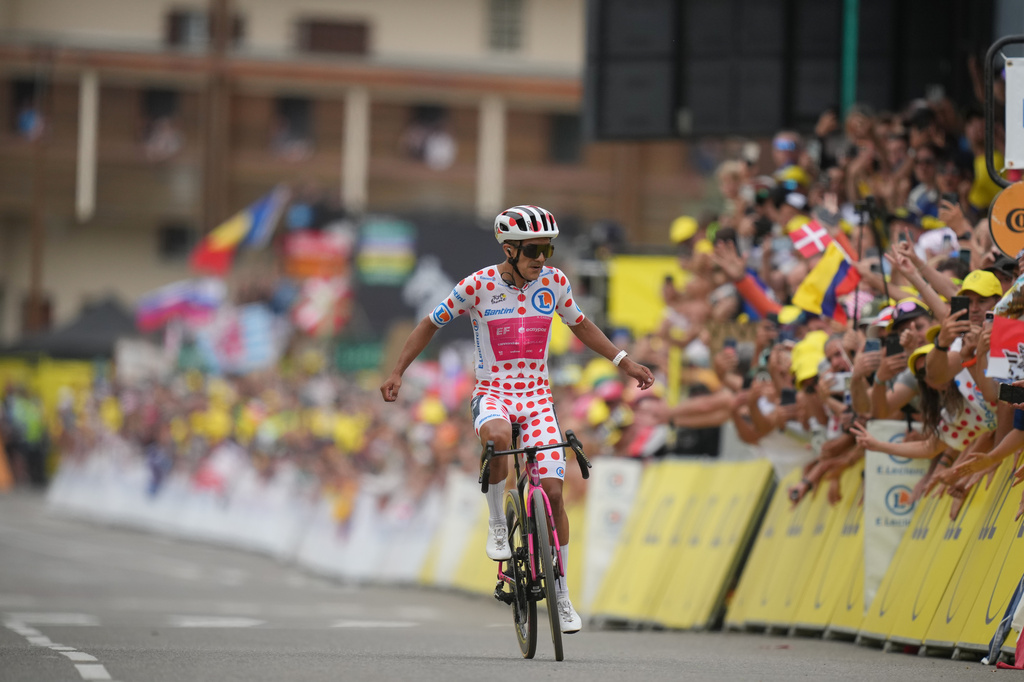 Ecuador's Richard Carapaz celebrates as he crosses the finish line to win the twentieth stage of the Tour de France cycling race with start in Le Bourg d'Oisans and finish in Alpe d'huez, France, Saturday, July 25, 2026. (AP Photo/Mosa'ab Elshamy)