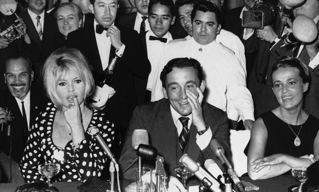 FILE - French Actress Brigitte Bardot, left, attends a news conference in Mexico City, Jan. 18, 1965. Seated next to her is producer Louis Malle and at right is French actress Jeanne Moreau. (AP Photo/File)