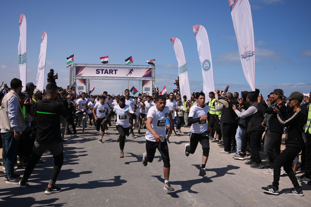 Palestinian runners take part in the 5-kilometer Palestine Marathon along the coastal road near Nuseirat in the central Gaza Strip, Friday, May 8, 2026. (AP Photo/Abdel Kareem Hana)