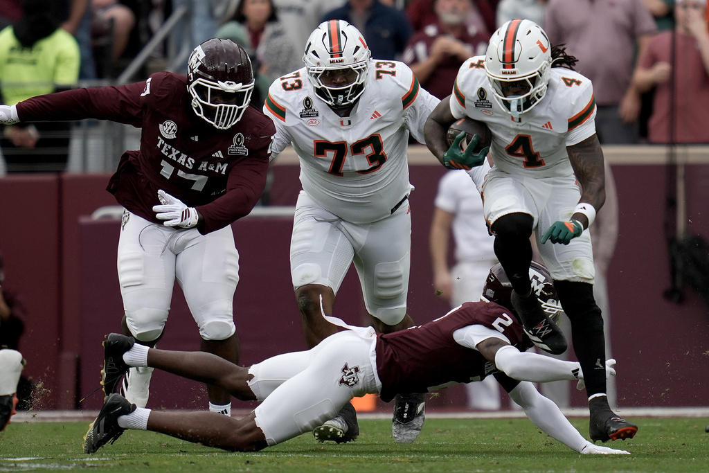 Miami running back Mark Fletcher Jr. (4) steps out of a tackle attempt by Texas A&M cornerback Dezz Ricks (2) during the second quarter in the first round of the NCAA College Football Playoff Saturday, Dec. 20, 2025, in College Station, Texas. (AP Photo/Sam Craft)