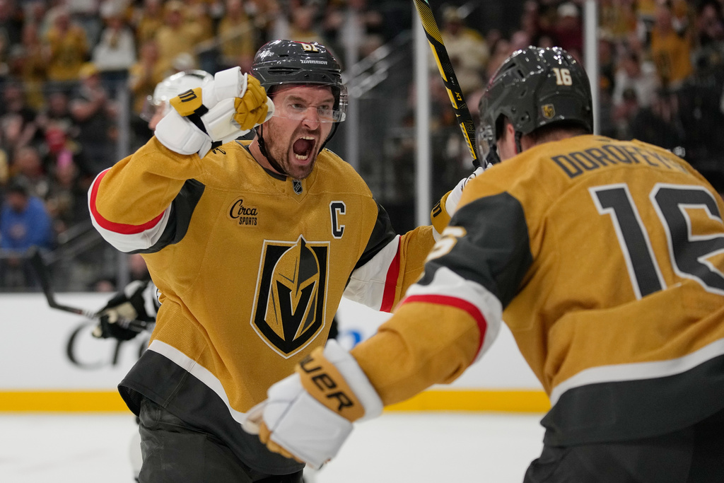 Vegas Golden Knights right wing Mark Stone (61) celebrates after Pavel Dorofeyev, right, scored against the Los Angeles Kings during the second period of an NHL hockey game Wednesday, Oct. 8, 2025, in Las Vegas. (AP Photo/John Locher)