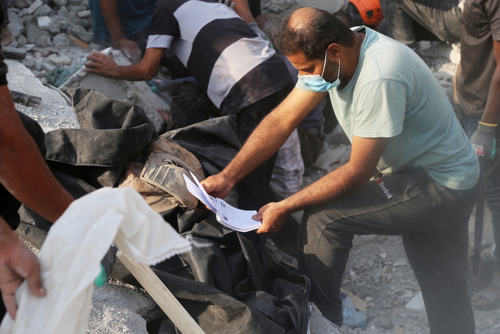 Rescue workers and residents search through the rubble in the aftermath of a strike on a girls' elementary school in Minab, Iran, Saturday, Feb. 28, 2026. (Abbas Zakeri/Mehr News Agency via AP)