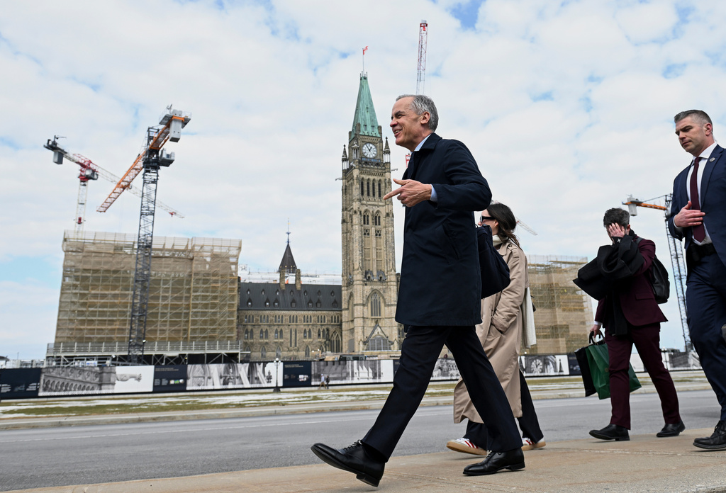 Canada's Prime Minister Mark Carney makes his way towards West Block on Parliament Hill in Ottawa, Ontario, Tuesday, March 10, 2026. (Spencer Colby/The Canadian Press via AP)