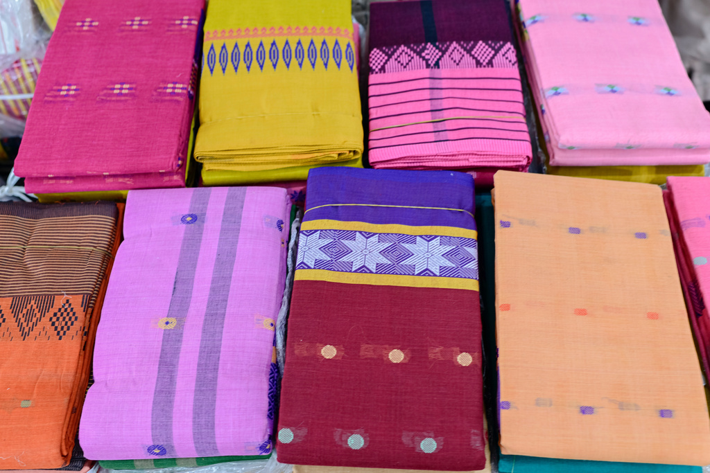 Tangail saris are displayed for sale at a weekly wholesale market in Tangail District, Bangladesh, Nov. 5, 2025. (AP Photo/Mahmud Hossain Opu)